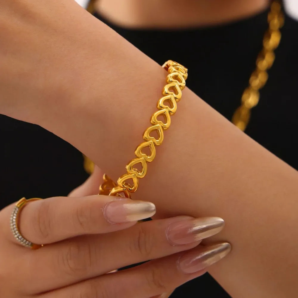 Gold bracelet on a wrist with a blurred background